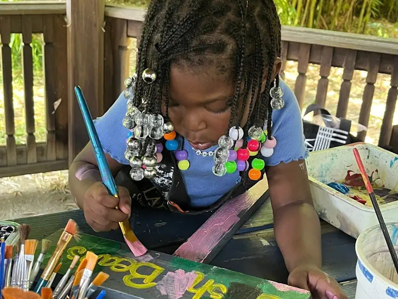 A young girl enjoying painting with watercolor