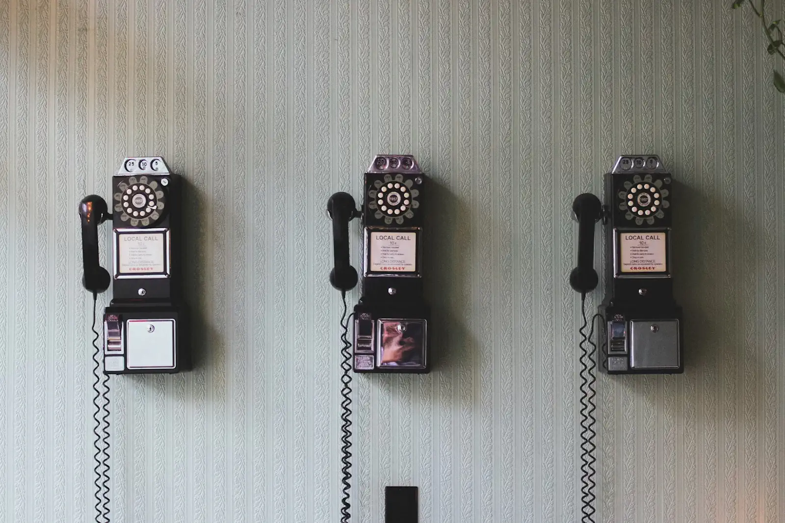 Picture of old payphones on a wall symbolizing disclosure of information