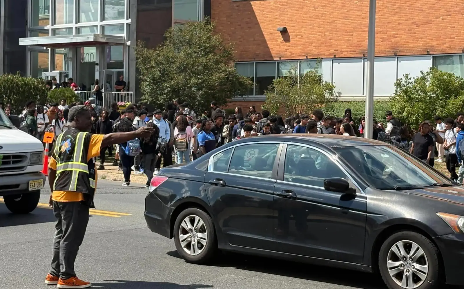 An Isles staff member directing traffic, an example of the articles and stories about Isles' impact on the community