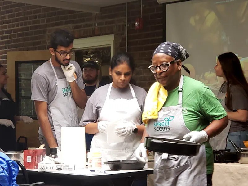 Volunteers, cooking with Pearl